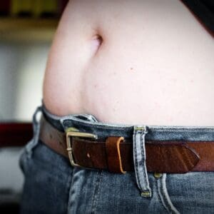 A close up of someone 's belly wearing jeans