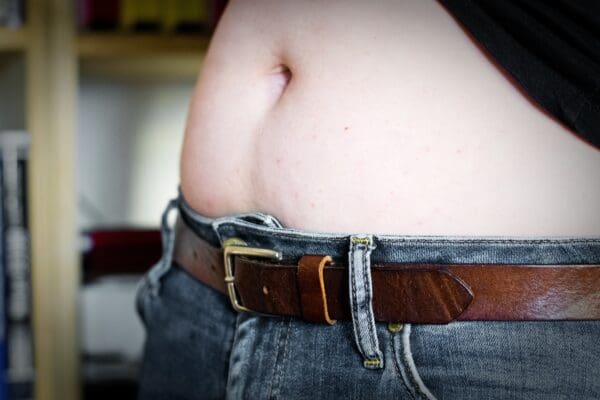 A close up of someone 's belly wearing jeans