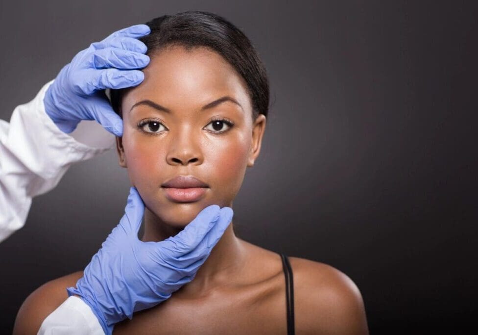 A woman getting her face waxed by an esthetician.